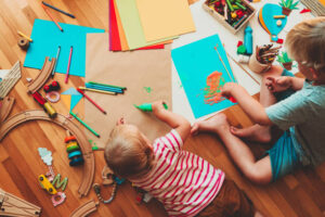 Kids draw and make crafts. Children with educational toys and school supplies for creativity. Background for preschool and kl play at home or daycare